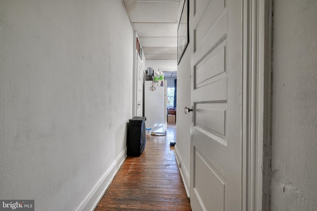 corridor with dark hardwood / wood-style flooring