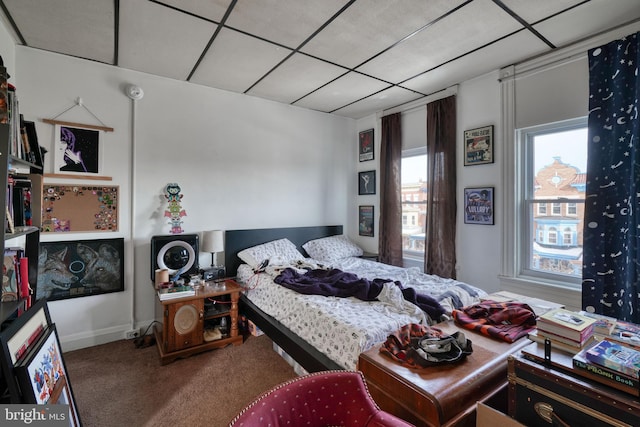 carpeted bedroom featuring a paneled ceiling