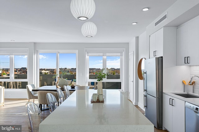 dining area with light hardwood / wood-style floors and sink