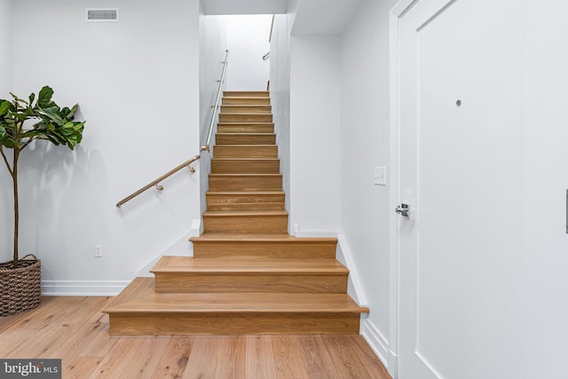 stairs with hardwood / wood-style floors