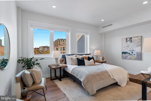 bedroom with hardwood / wood-style flooring