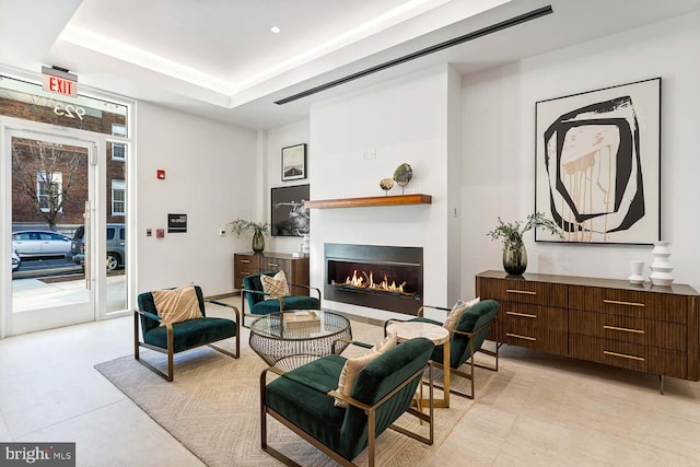 living area with a tray ceiling