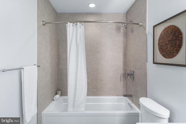 bathroom with shower / bath combination with curtain and toilet