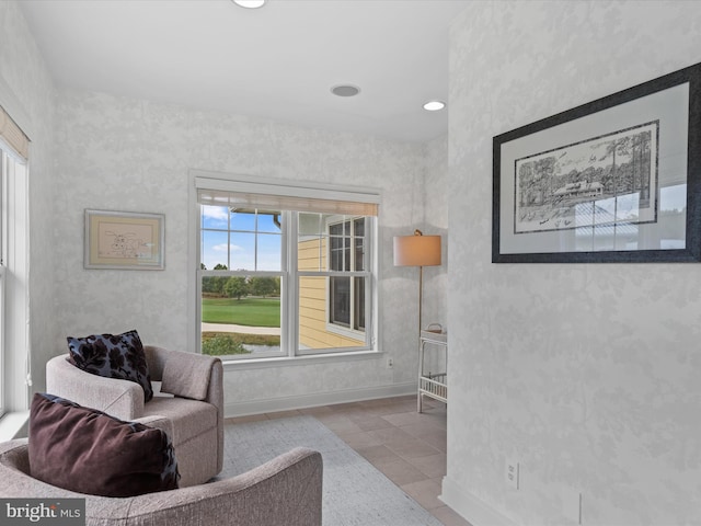 living area with a wealth of natural light and light tile patterned floors