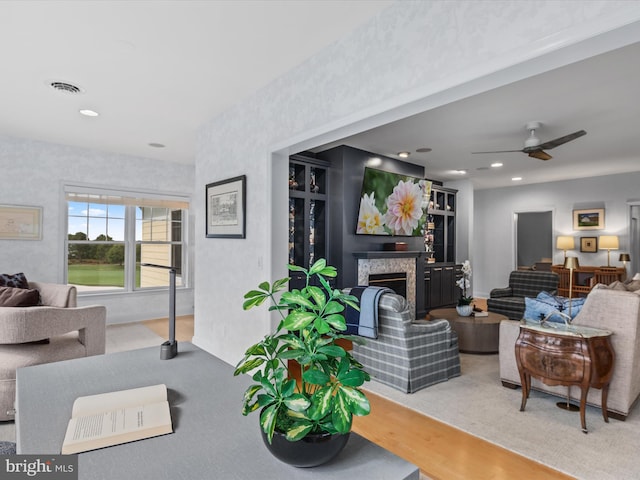 living room featuring wood-type flooring and ceiling fan