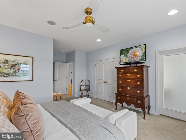 carpeted bedroom featuring a closet and ceiling fan