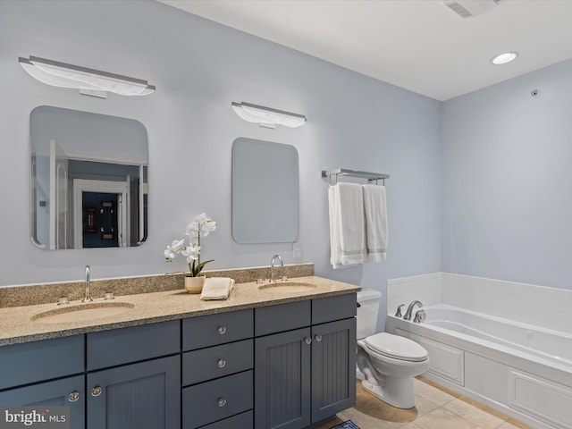 bathroom featuring vanity, a bathing tub, toilet, and tile patterned floors