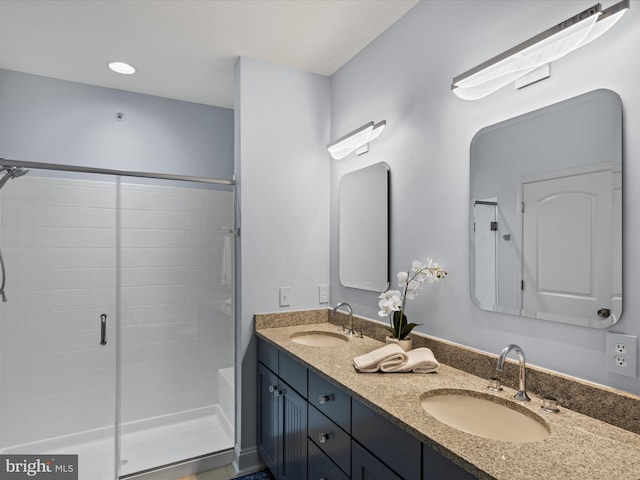 bathroom with vanity and a shower with shower door