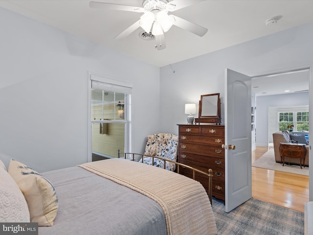 bedroom with ceiling fan and hardwood / wood-style flooring