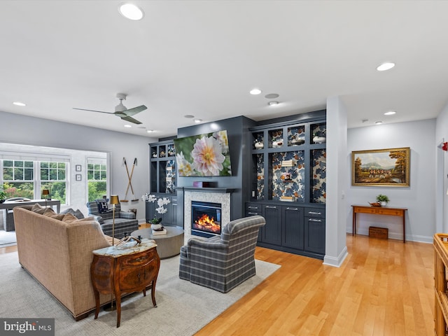 living room featuring ceiling fan and light wood-type flooring