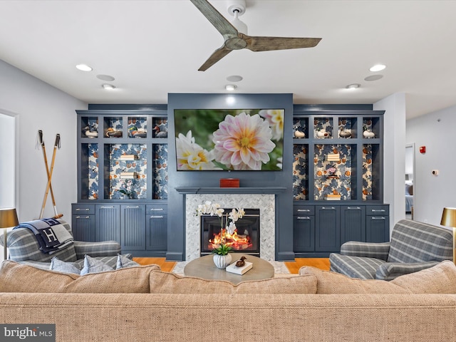 living room with ceiling fan and light hardwood / wood-style flooring