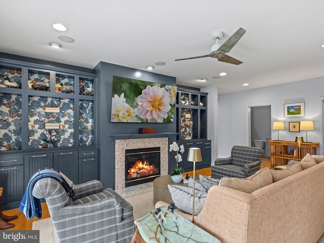 living room with ceiling fan and light hardwood / wood-style flooring