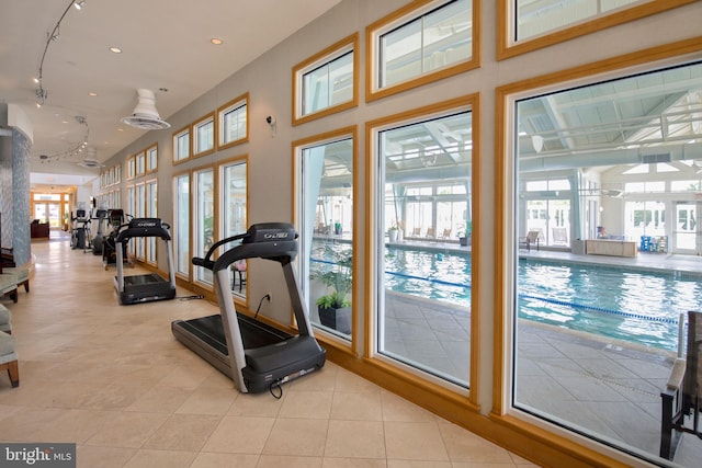 workout room featuring light tile patterned floors