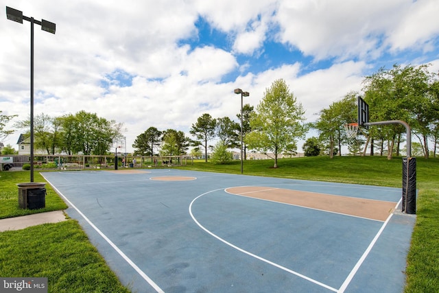 view of basketball court with a yard