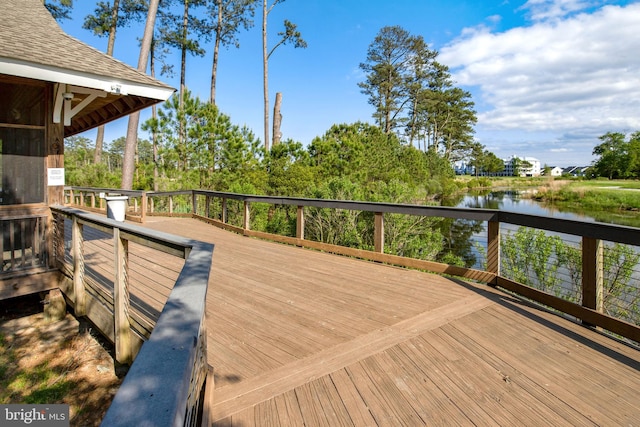 wooden deck featuring a water view