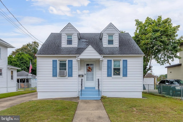 cape cod home featuring a front yard