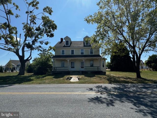 view of front of house featuring a front yard and a porch