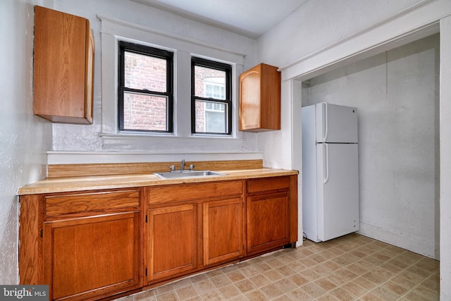 kitchen with sink and white refrigerator