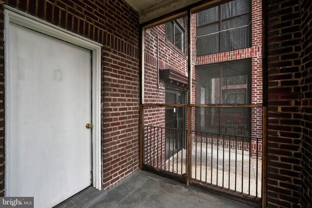 property entrance with brick siding