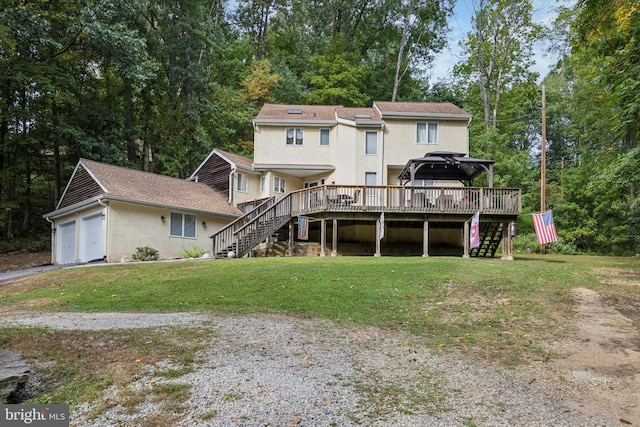 back of house featuring a deck and a lawn