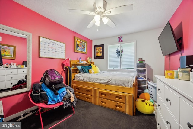 bedroom with ceiling fan, carpet floors, and a textured ceiling