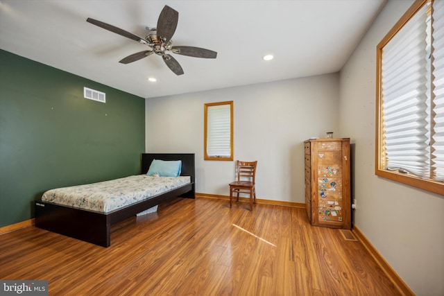 bedroom with ceiling fan and hardwood / wood-style floors