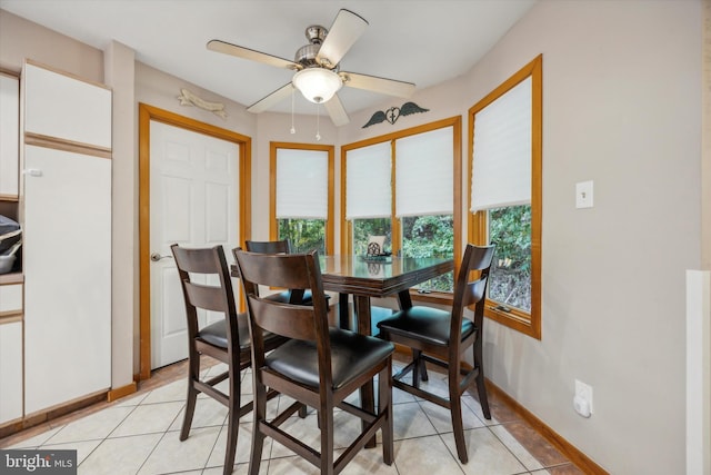 tiled dining area featuring ceiling fan