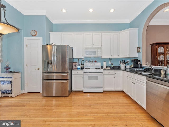 kitchen with white cabinets, stainless steel appliances, and light hardwood / wood-style flooring