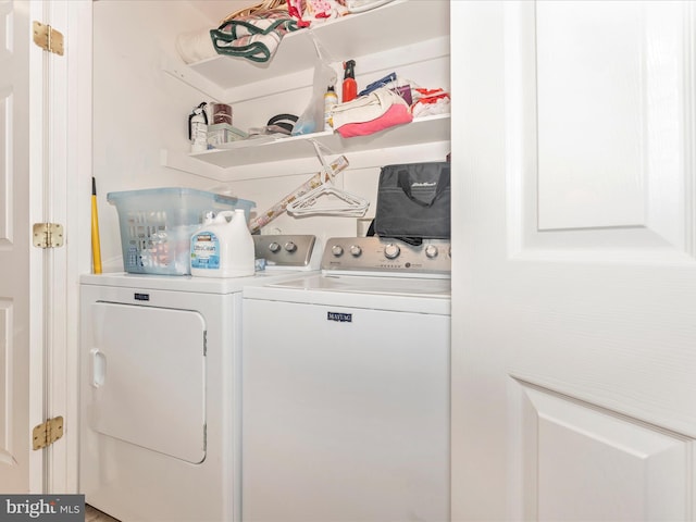 clothes washing area with separate washer and dryer