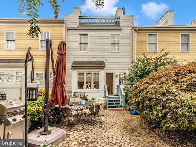 rear view of property featuring a patio