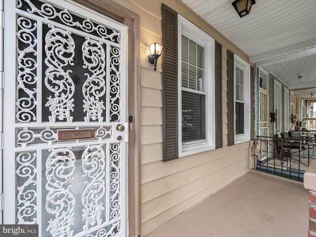 view of exterior entry featuring a porch