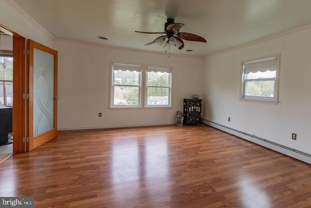 unfurnished room featuring a baseboard heating unit, ornamental molding, hardwood / wood-style floors, and ceiling fan