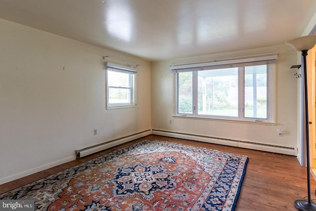 empty room featuring a baseboard radiator and hardwood / wood-style floors