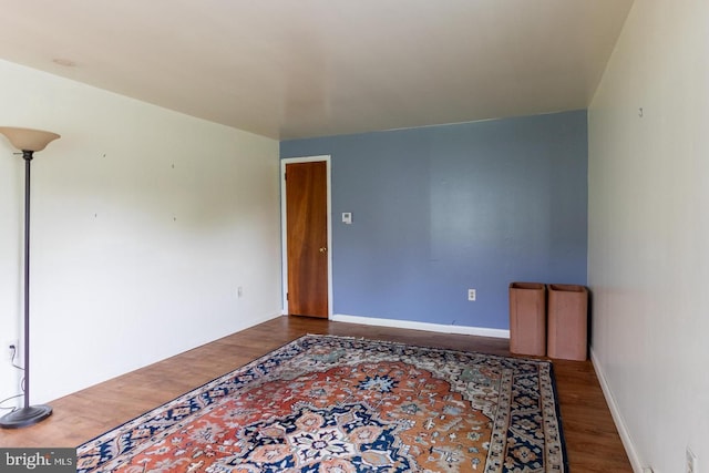 unfurnished room with hardwood / wood-style flooring