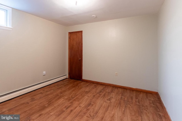 spare room with light hardwood / wood-style floors and a baseboard radiator