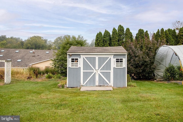 view of outbuilding featuring a lawn