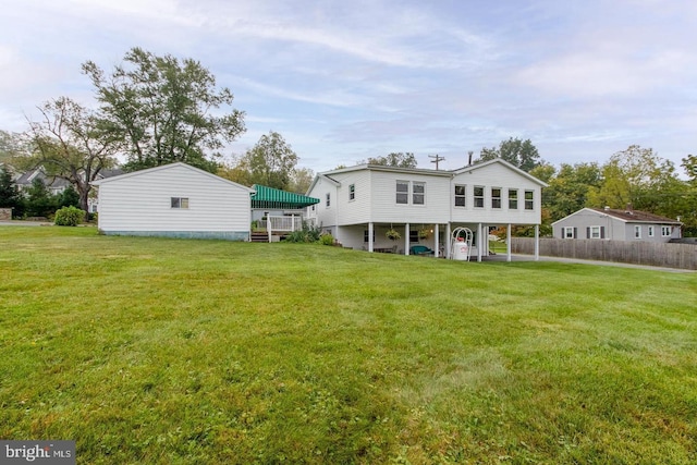 rear view of house featuring a lawn