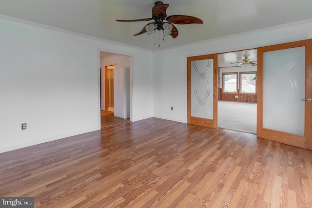 spare room with crown molding, ceiling fan, and light hardwood / wood-style flooring