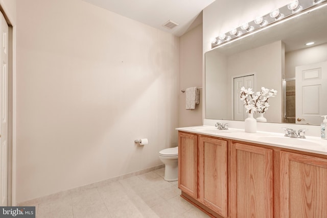 bathroom with walk in shower, vanity, toilet, and tile patterned floors