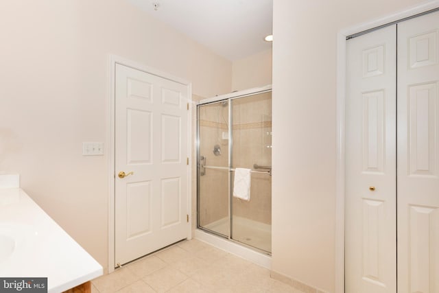 bathroom featuring vanity, tile patterned flooring, and an enclosed shower