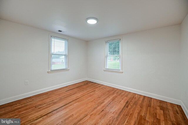 empty room with hardwood / wood-style flooring