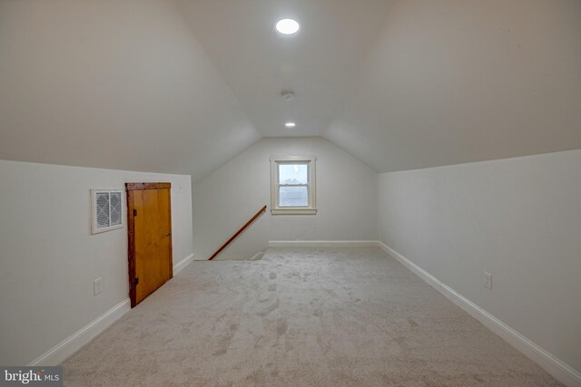 additional living space with lofted ceiling and light colored carpet