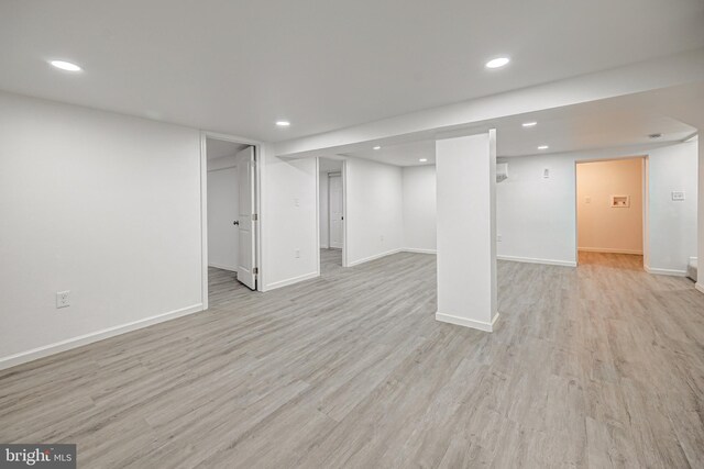 basement with light hardwood / wood-style floors