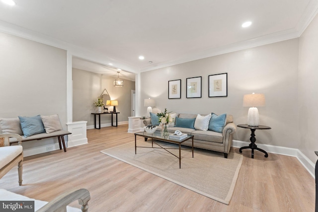 living room with light hardwood / wood-style flooring and crown molding