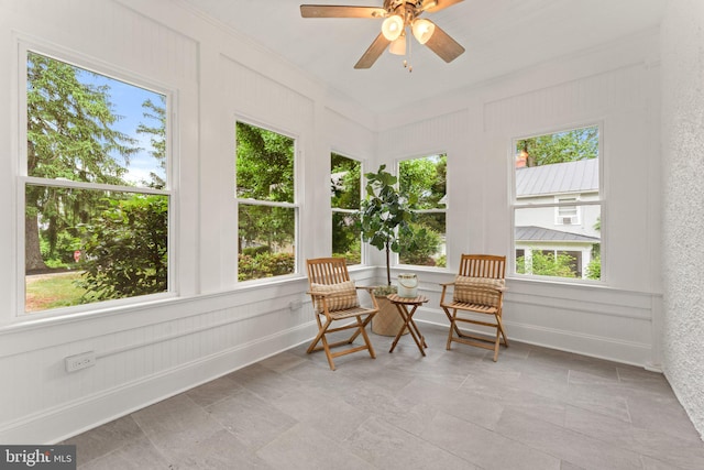 sunroom / solarium with ceiling fan and a healthy amount of sunlight