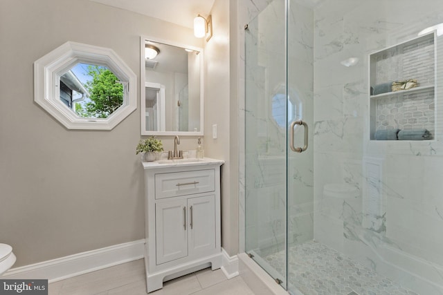 bathroom with walk in shower, tile patterned flooring, vanity, and toilet