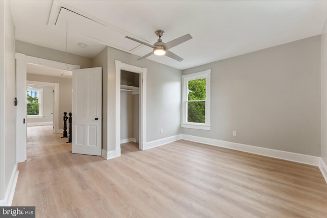 unfurnished bedroom featuring ceiling fan, light hardwood / wood-style flooring, and a closet