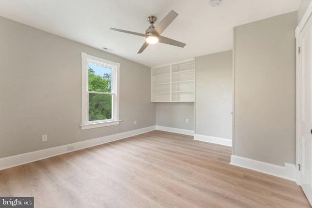 empty room with light hardwood / wood-style floors and ceiling fan