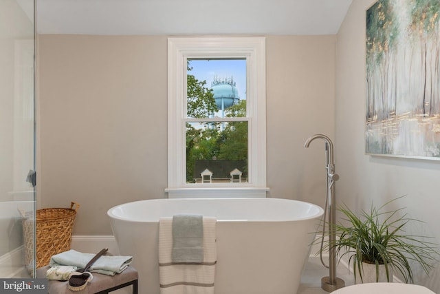 bathroom with a tub to relax in