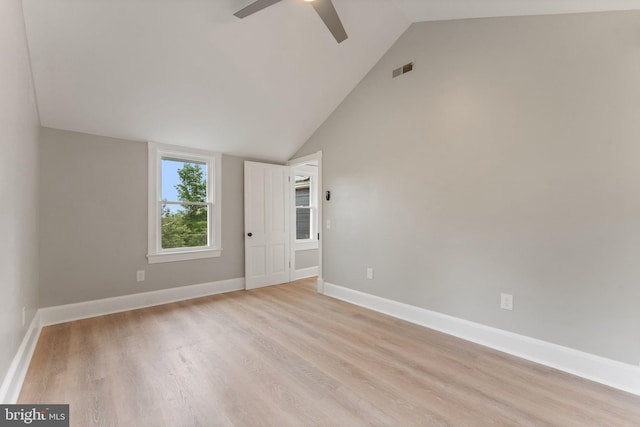 unfurnished room with light wood-type flooring, vaulted ceiling, and ceiling fan